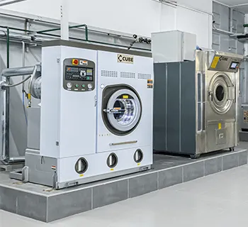 Industrial washing machines at a professional laundry facility